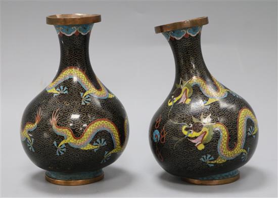 A pair of Chinese cloisonne squat bottle shaped vases, decorated with dragons amid scrolls, on a black ground, height 16cm